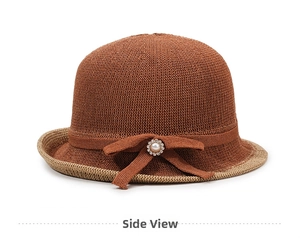 Detail of knitted bucket hat with elegant bow, faux pearl and rhinestone embellishment