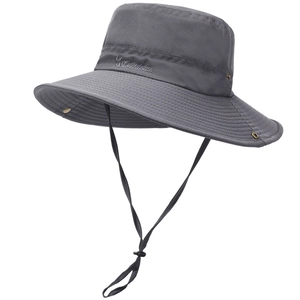 Detail of dark grey sun hat featuring metal vents, adjustable chin strap and outdoor fabric