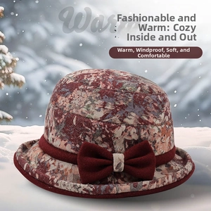 Close-up of winter floral bucket hat for elderly women with decorative red bow