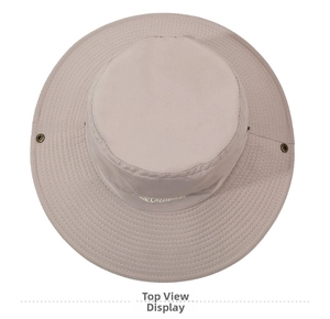 Top-down macro view of beige sun hat showing fine stitching and metal ventilation eyelets