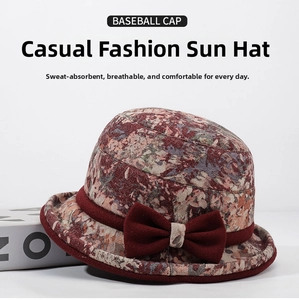 Close-up of winter floral bucket hat with a large red bow detail for women