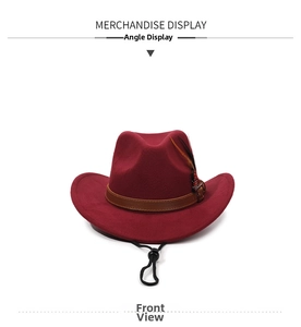 Close-up of wine red western cowboy hat with leather band, feather, and wind string
