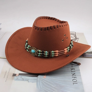 Chapeau de cowboy marron en daim avec bandeau perlé turquoise sur fond Kinfolk