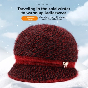 Detail view of thickened thermal lining on red plaid winter hat for elderly women