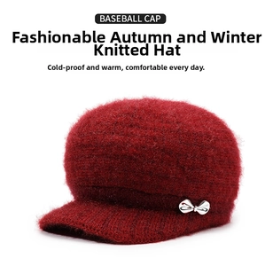 Detailed knit texture of burgundy thermal winter hat with silver bow decoration