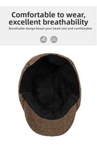 Detail view of the brown tweed newsboy cap showing black inner lining and metal buckle