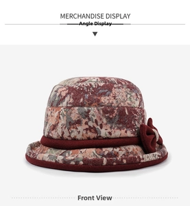 Close-up of floral print winter bucket hat for women with a decorative red bow accent