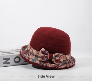 Detail of burgundy wool bucket hat with vintage floral brim and elegant fabric bow