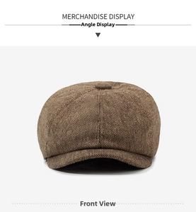 Front view detail of a brown herringbone newsboy hat showing fine fabric texture and top button
