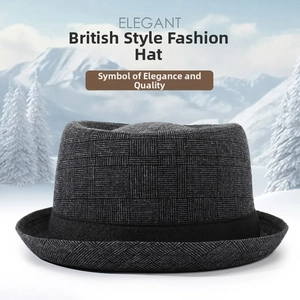 Classic grey checkered fedora hat with black band displayed against a snowy mountain backdrop