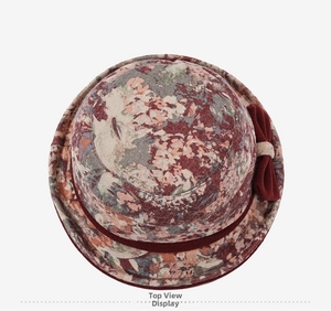 Macro detail of elderly women floral bucket hat with textured fabric and red bow