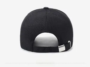 Detail of black corduroy baseball cap back with adjustable silver metal buckle strap
