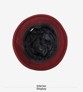 Detailed view of the quilted black inner lining and thermal padding of the cloche hat