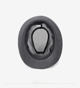 Close-up of breathable honeycomb mesh lining and sweatband inside the woven summer fedora hat