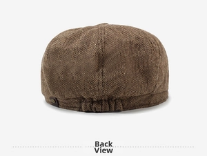 Detailed back view of brown newsboy cap with elastic band and metal rivet detail