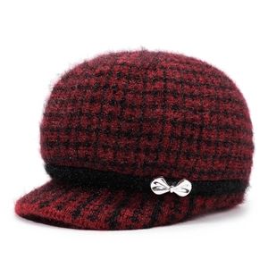 Women's warm knit visor hat in red and black plaid with a metallic bow detail