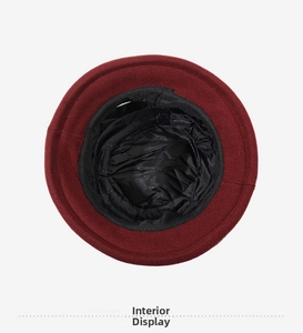 Detail showing the black inner lining and smooth stitching of the red winter bucket hat
