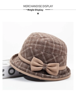 Detailed view of a brown plaid woolen bucket hat featuring a stylish large side bow accent