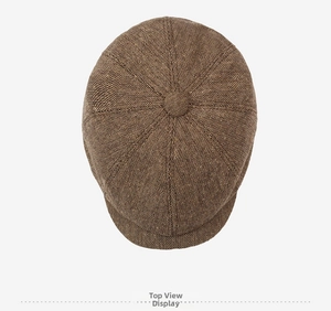 Top-down view of retro newsboy cap showing textured wool-like fabric and top button detail