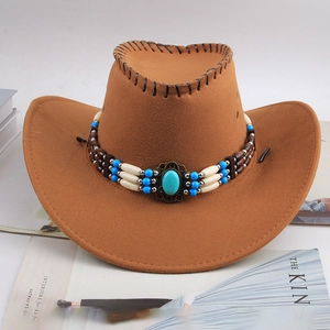 Détail d'un chapeau de cowboy marron avec perles bleues et ornement turquoise
