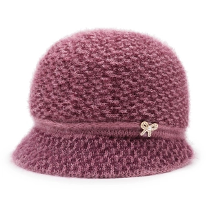 Close-up of purple knit hat for elderly women with pearl bow brooch detail