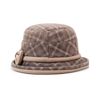 Detailed view of vintage brown plaid wool cloche hat with an elegant side bow ornament