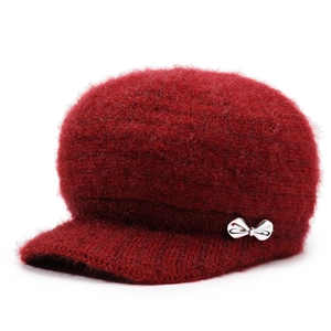 Detail view of wine red knit winter hat with velvet texture and silver bow accessory