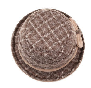 Close-up of brown plaid wool cloche hat featuring a decorative bow on the side