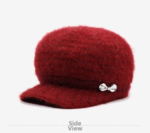 Side view of dark red knit newsboy hat with fleece lining and silver bow detail