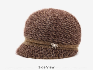 Close-up of brown plush winter hat featuring rhinestone and pearl bow detailing