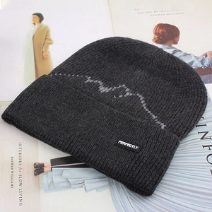 Detailed close-up of dark grey knit beanie with perfectly patch and wave pattern