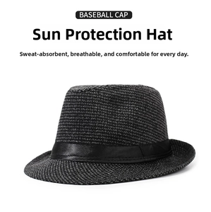 Detail of black and white woven fedora hat featuring a glossy black satin ribbon band