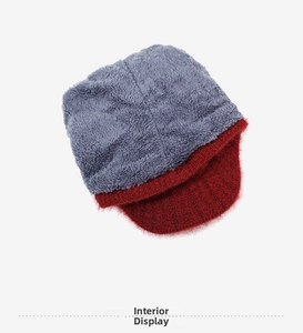 Detailed view of the warm thick fleece lining inside a red knitted winter hat for women