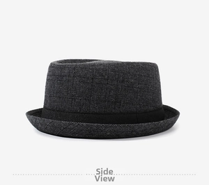 Detail view of dark grey plaid fedora hat with textured fabric and grosgrain ribbon