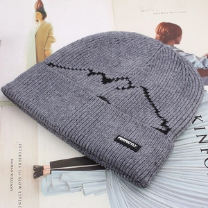 Close-up of a ribbed knit beanie with mountain jacquard and Perfectly brand label