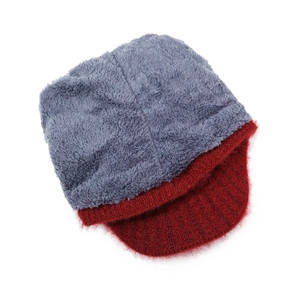 Close-up of winter knit cap with grey plush top and burgundy ear flaps for elderly women
