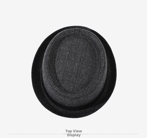 Top down view of a charcoal gray fedora hat featuring a woven checkered texture and band