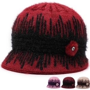 Detailed close-up of knit texture and rhinestone floral decor on winter wool bucket hat