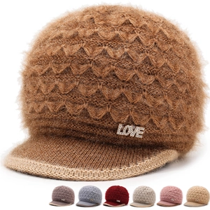 Detail of knitted winter hat for women showing soft faux mink fur texture and LOVE rhinestones