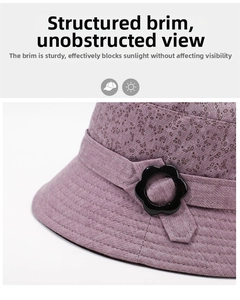 Detail showing purple floral pattern bucket hat with reinforced brim stitching and flower buckle