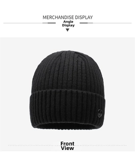Detail of black ribbed knit beanie with embossed logo button and warm acrylic fabric