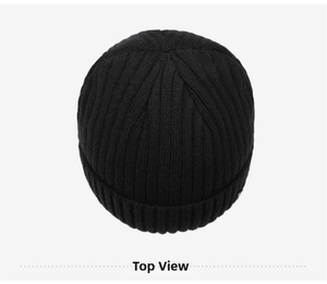 Top view of a black ribbed knit beanie showing thick vertical texture and folded brim