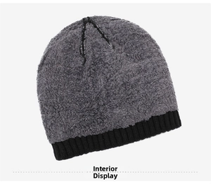 Detail view of the warm grey faux shearling lining inside the black knitted winter hat