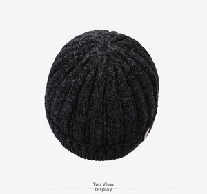 Top down view of black ribbed knit beanie showing thick texture and warm winter fabric