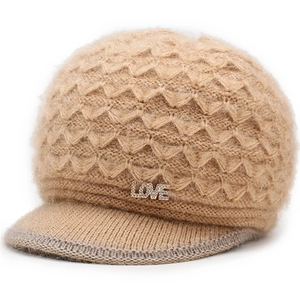Close-up of light brown plush knitted hat with LOVE diamond pendant and textured pattern