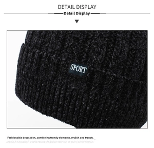 Detail of black chenille knit beanie featuring a SPORT woven label and ribbed texture