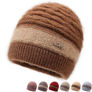 Detailed close-up of winter knit hat featuring striped pattern and LOVE metal emblem