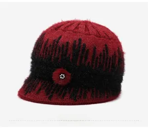 Detail view of winter knit hat featuring deep red contrast texture and floral rhinestone
