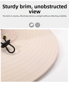 Detail of beige sun hat featuring reinforced stitching and adjustable drawstring