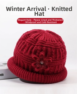 Close-up of dark red knitted winter hat for elderly women with warm fleece lining and flower